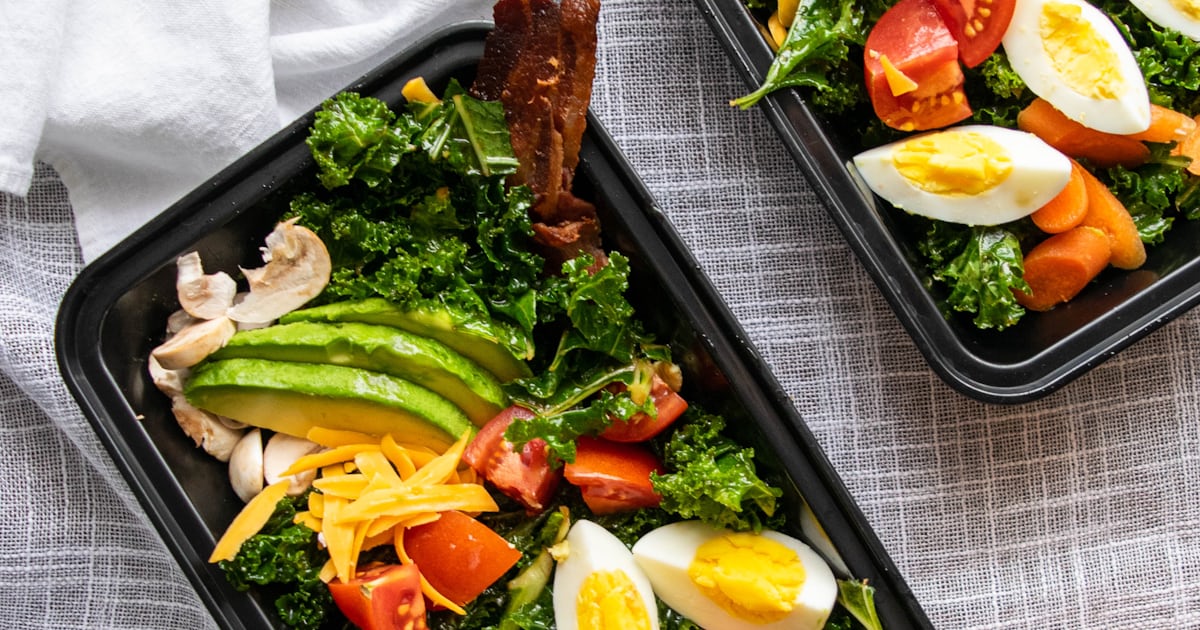 Meal prep containers with portioned meals on a kitchen counter, ready for the week